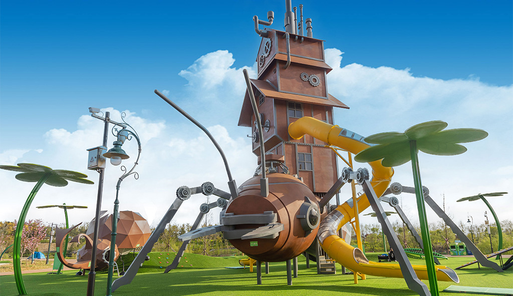 Completed custom insect-themed playground with climbing structures and slides